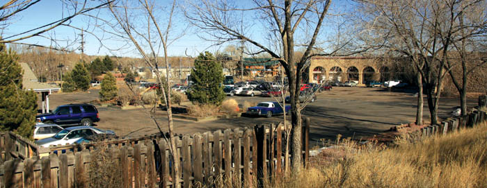 The Midland roundhouse (now Van Briggle Pottery) is at far right, with its parking lot going west to the planters, which 
mark the start of the Ghost Town property (a corner of the the latters building is at far left) Photo looks northeast, with the Highway 24/21st Street intersection 
beyond.
Westside Pioneer photo