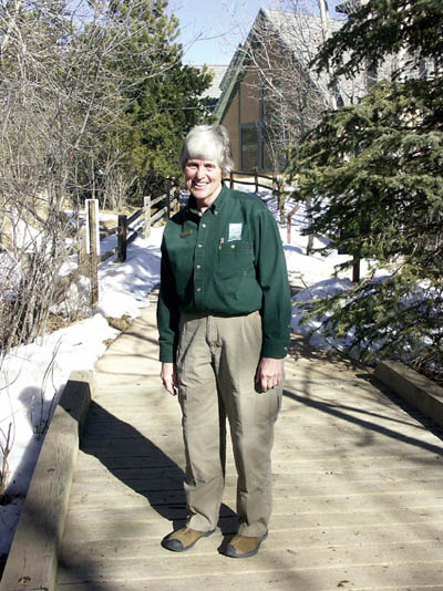 Donna Scheeter, outgoing 
Superintendent of Interpretation for the county's nature centers, stands on a Bear 
Creek 
Center footbridge. 
Westside Pioneer photo