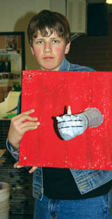Holmes student Dan Smith wears a gauntleted arm in one
of 25 Pandoras Box pieces the school will have in an
exhibit with the Watercolor Society.
Westside Pioneer photo