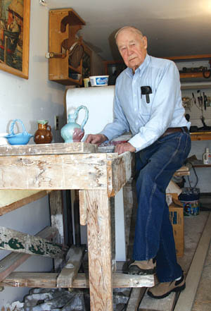 Fred Wills demonstrates the kick wheel he still uses to make pottery originals in his garage. 
Westside Pioneer photo