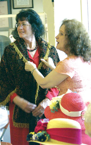 Rita Wilhelm (right), who made all the clothes, dresses up an audience volunteer (Lona Dee Lang) in a hat, cape and gloves. 
Center.
Westside Pioneer photo