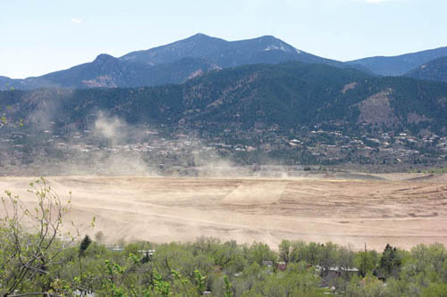 Some dust blows off Gold Hill Mesas dam face above Highway 24 during a windy afternoon May 10 (photo looks 
south from Promontory Point Park).
Westside Pioneer photo
