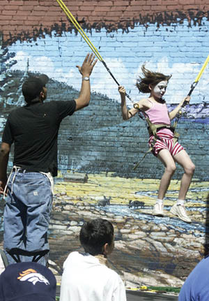 A face-painted youngster enjoys a swing ride in the
childrens activity area in the parking lot on the south side
of the 2600 block during Territory Days May 27-29. The
background mural is on the wall of the building west of the
lot.
Westside Pioneer photo