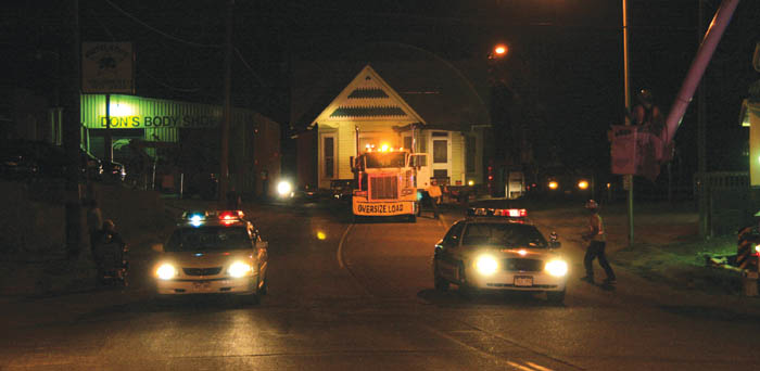 Moving south on 21st Street at about 2 a.m. June 11, the former 2102 W. Colorado Ave. house needed the full width 
of the roadway en route to its new locale at 1128 Calvert St. Two police cars lead the way. The shot was taken during a brief delay near Sheldon Avenue.
Westside Pioneer photo