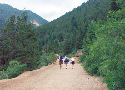 Hikers walk up the closed-off section of Gold Camp Road below Tunnel 3 recently.