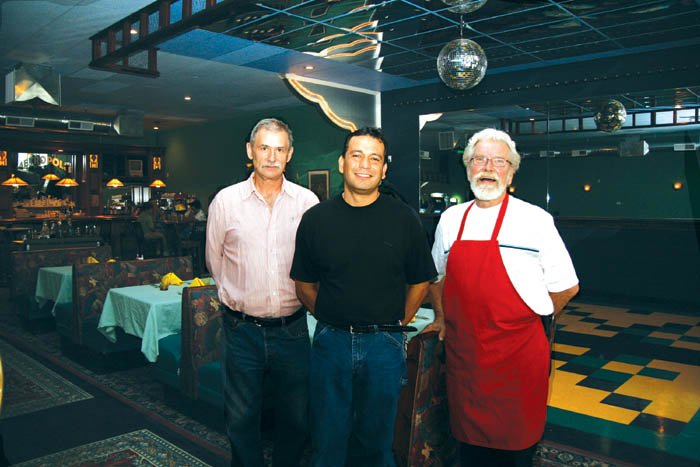 The one-time Checkers Auto store building at 1201 W.
Colorado Ave. received a major facelift, inside and out,
over the past year during a project to create the Metropolis
restaurant... The key figures in the business (from left)
co-owners Jeff Chevalier and Luis Ortiz and head cook Blair
Hall. Behind them can be seen the dance floor, a table from
the Broadmoor and the solid-mahogany bar.
Westside Pioneer photo