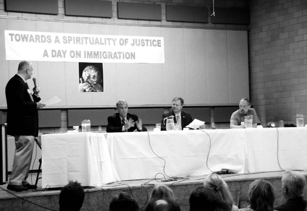 Moderator Tim Fuller (standing) addresses U.S. Senate
candidates Democrat Mark Udall (left), Republican Bob Schaffer and Bob Kinsey of the Green Party at the start
of a forum Aug. 16 in Sacred Heart Churchs gym. Doug Campbell of the American Constitution Party arrived a few minutes later.
Westside Pioneer photo
