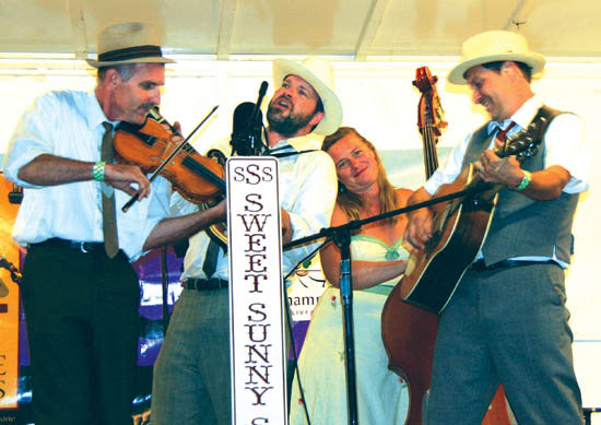 The members of Sweet Sunny South, one of the four bands
at this year's Fiddles, swing together on a song during their evening set.
Westside Pioneer photo