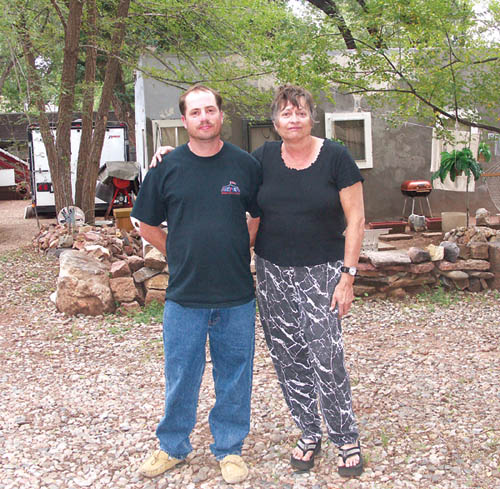 Brandon Biemel and his mother Sandra stand outside
the cottage they own in which they and another tenant cornered a fugitive until police could arrive to arrest him Aug. 25. 
Westside Pioneer photo