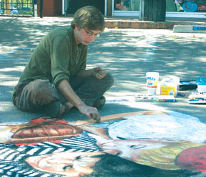 Jason Baalman chalks his rendition of Norman Rockwells
Marbles Champion during the Art on the Avenue event in
Old Colorado City Sept. 24.
Westside Pioneer photo