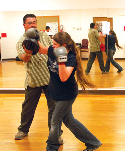 Instructor Moses Barela works on boxing combinations with West Middle School sixth-grader Meghan Conover during a 
recent class. The class is open to ages 10 to 16.
Westside Pioneer photo