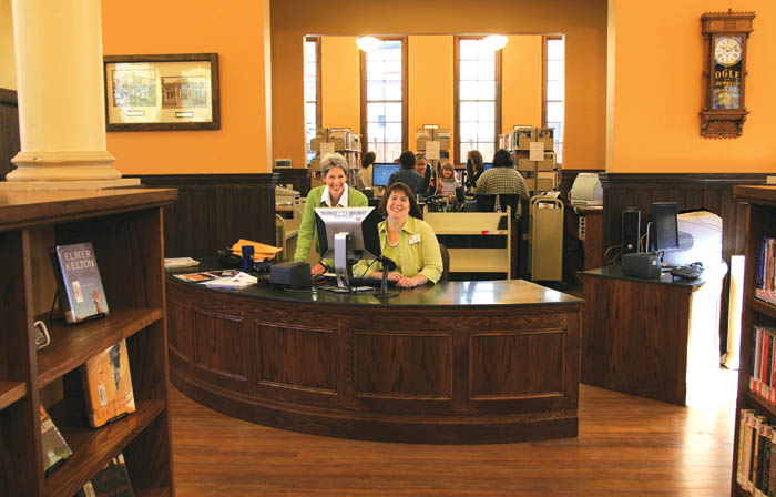 Old Colorado City Library employees Beth Cook (left)
and Deborah Bonifas greet patrons from the new
semicircular front desk, which is styled after the 1904
Carnegie original. Shot from the main entrance, the
photo shows much of the renovated interior Oct. 23
after a six-month closure for reconstruction. A grand
opening is scheduled Nov. 17.
Westside Pioneer photo