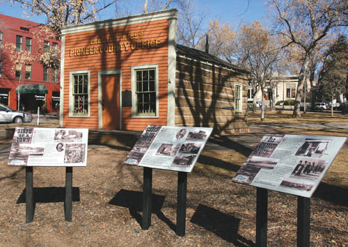 City Parks developed the information boards about (Old)
Colorado City and Bancroft Parks Garvin Cabin that are in the foreground. In the background, on the near (east)
side of the cabin, the Old Colorado City Historical Society plans to erect a perrmanent, eight-sided granite monument
 in conjunction with the sesquicentennial celebration  that will explain the history of early El Paso County and Colorado City.
Westside Pioneer photo