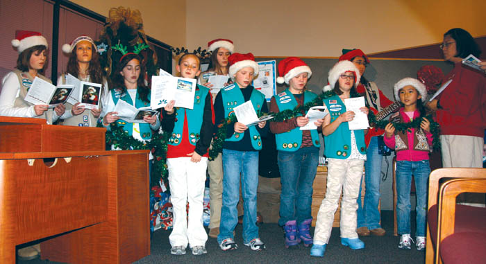 Girl Scouts sing carols during the tree-lighting ceremony at Silver Key Senior Services Dec. 1.
Westside Pioneer photo