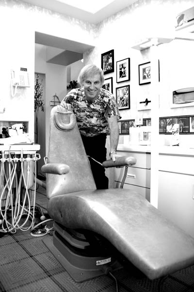 Standing beside the chair he once hand-trucked 14 blocks
up Colorado Avenue, dentist Michael Wahl displays the form he used. 
Westside Pioneer photo